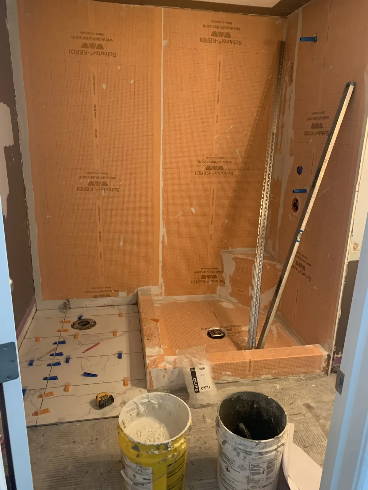 Calgary bathroom before tile renovation — dated cladding and finish