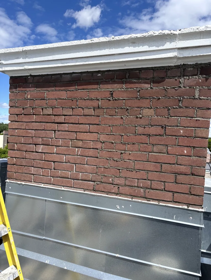 Brick repointing in progress in Calgary, failed mortar raked out and fresh matched joints installed