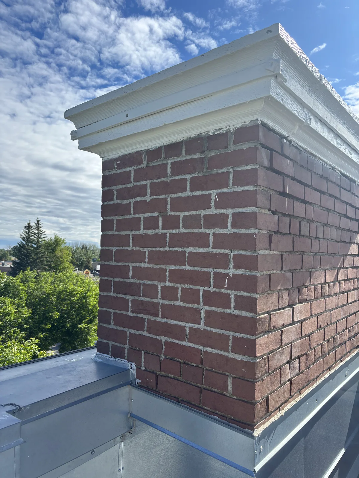 Red brick chimney on the CIBC building in Calgary being repointed