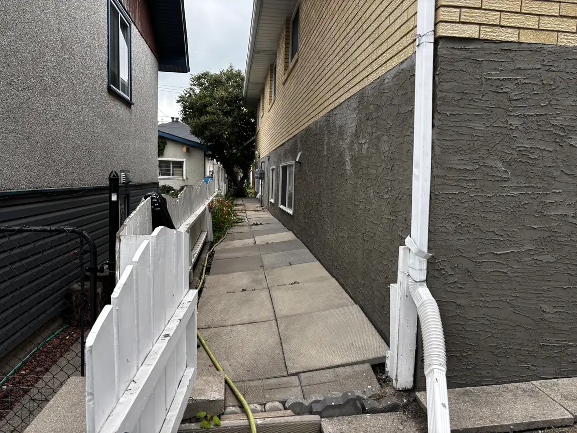 Fresh parging band completed along a multi-unit walkway in Calgary