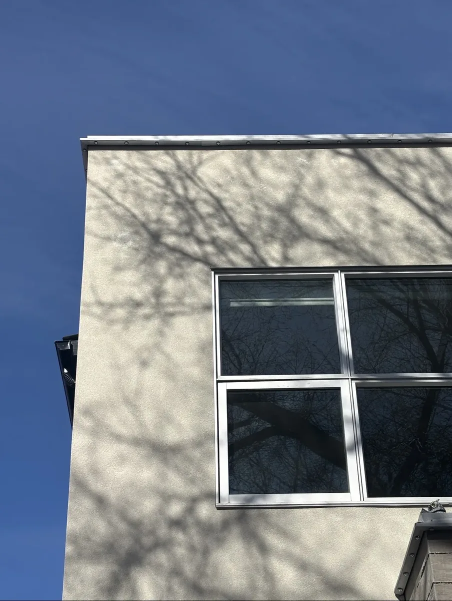 Calgary EIFS woodpecker repair after — holes filled, texture-matched and weather-tight