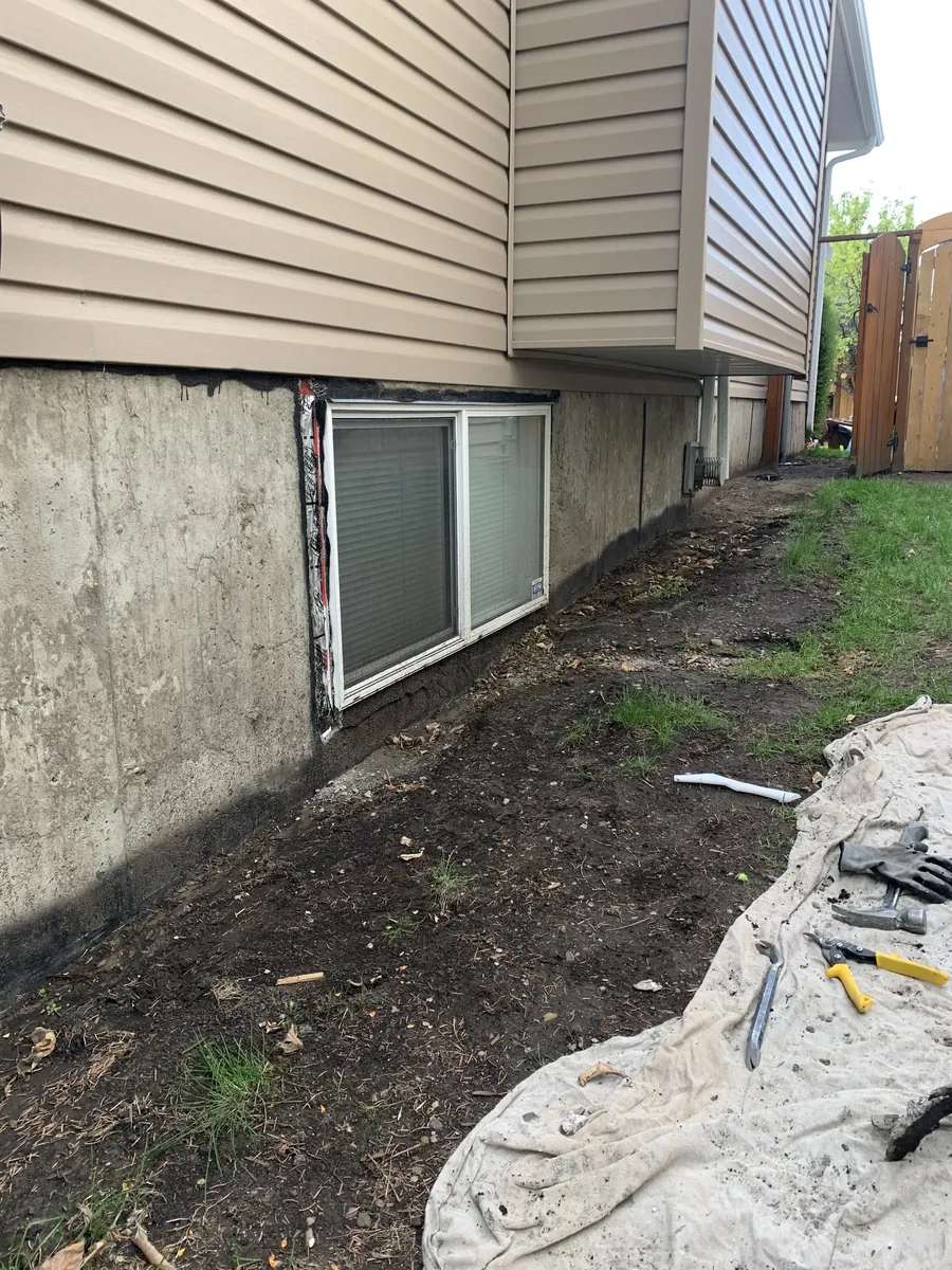 Calgary foundation parging before repair — crumbling and spalling visible