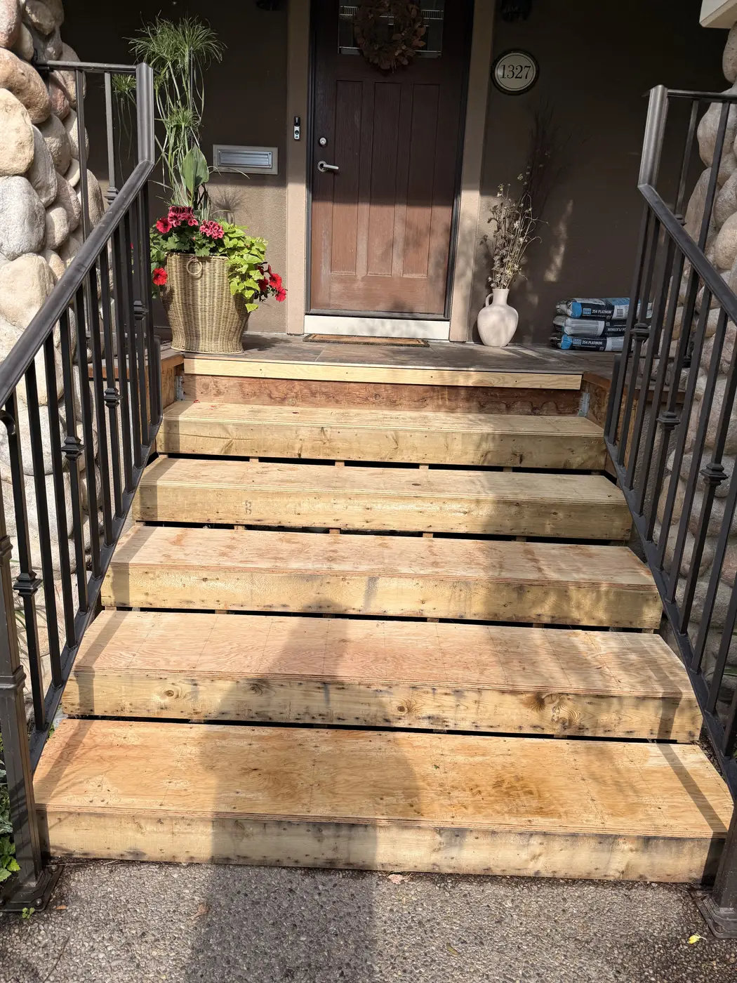 The same Calgary front entry stairs before, weathered wood treads