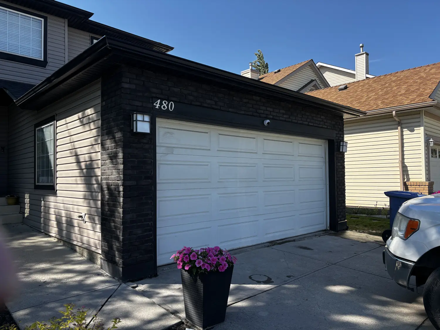 Calgary garage refinished in dark brick-format stone veneer