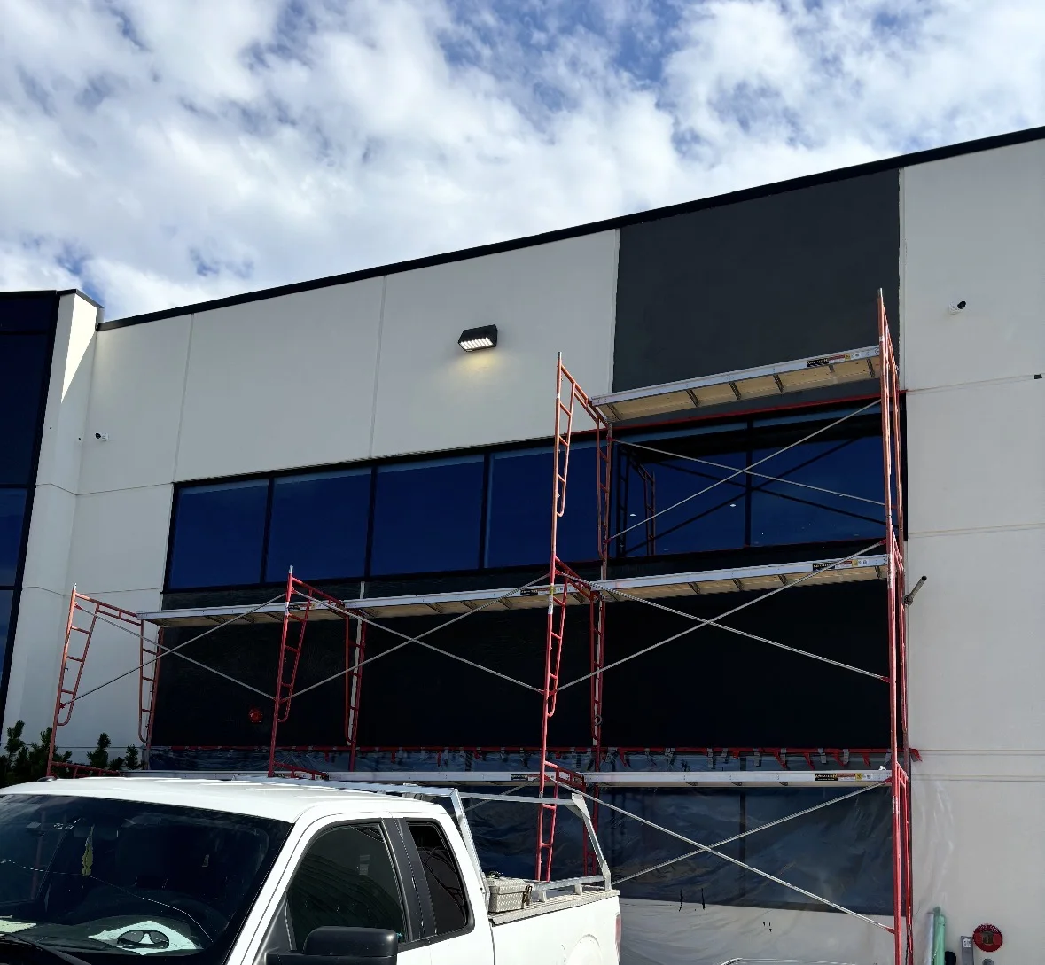 Calgary commercial building exterior with Graphex-coated stucco facade — modern white and black panel finish