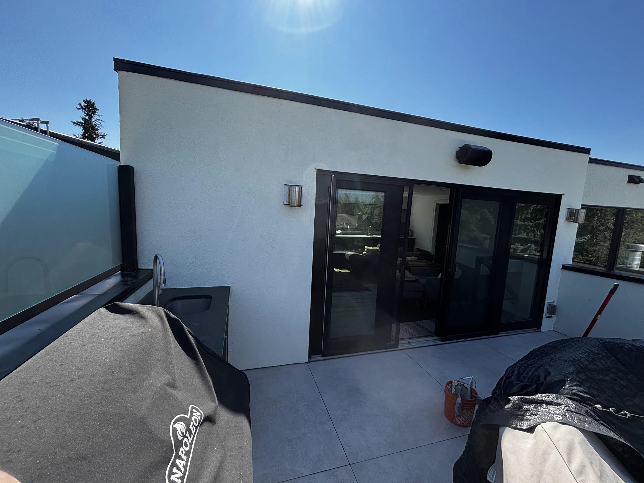 Finished acrylic stucco finish on a modern Calgary wall, one continuous colour-matched surface, stucco recoat, Calgary