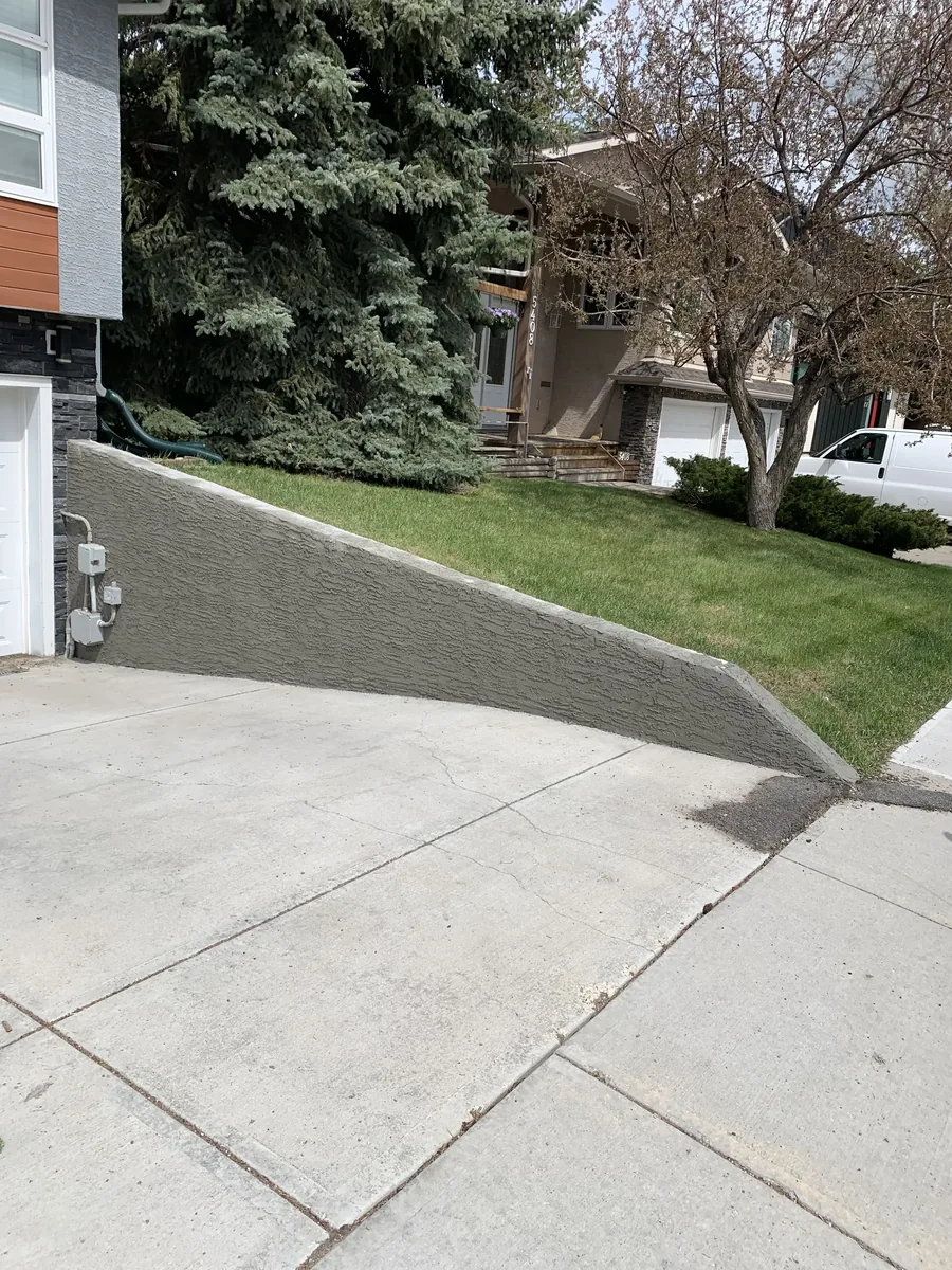 Calgary retaining wall parging after — rebuilt corners, smooth finish