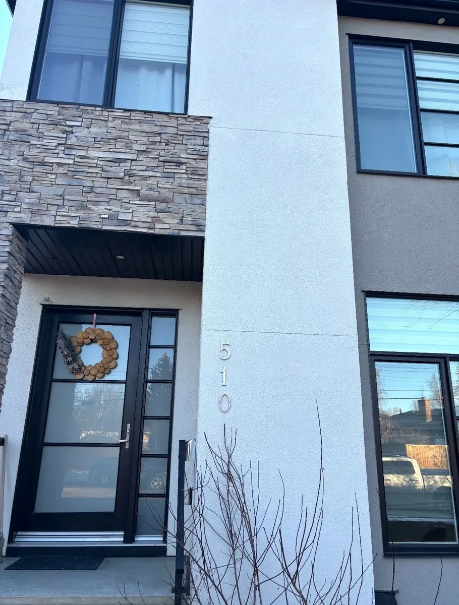 Calgary stone facade falling repair after — stones re-installed, mortar joints re-pointed, clean entryway facade