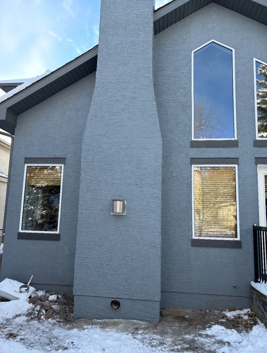 Calgary stucco chimney chase finished and colour-matched to the house