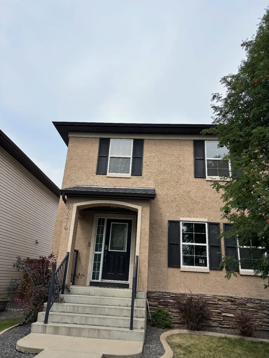 Calgary stucco wall after finish re-coat — fresh colour-matched texture finish