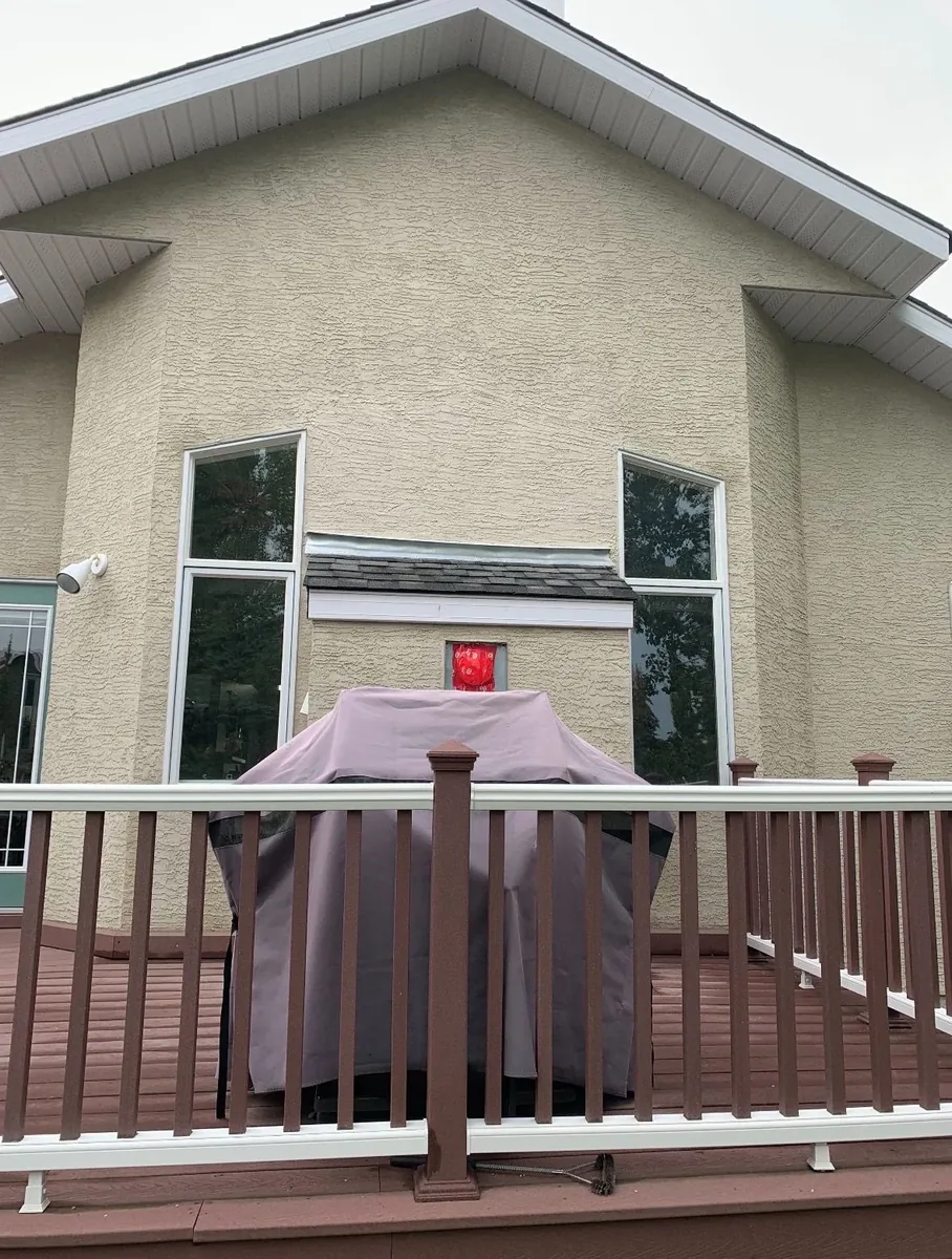 Calgary stucco wall leak repair after — re-flashed, re-stuccoed, and texture-matched section above window