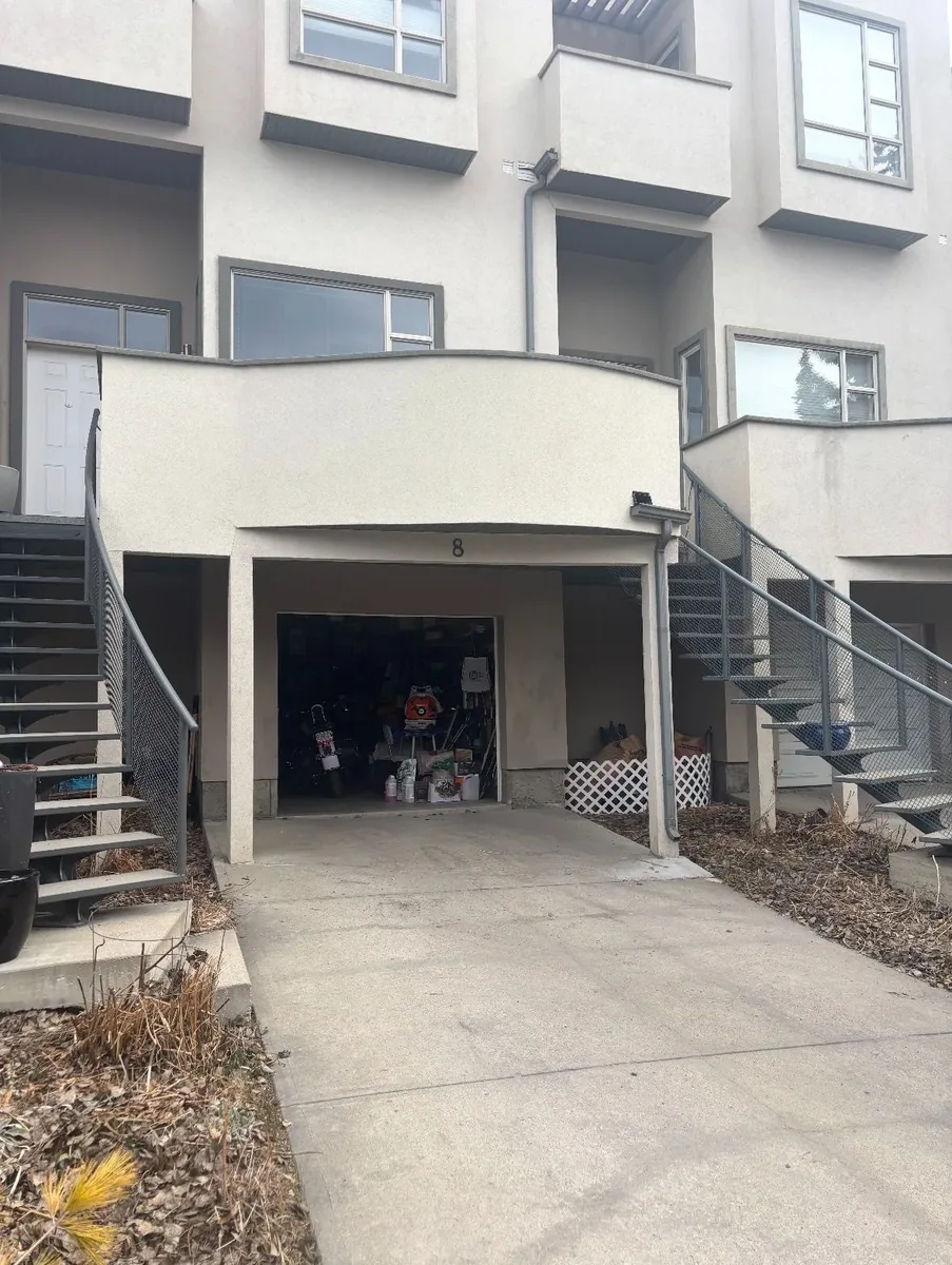Calgary townhouse stucco re-coat completed — clean uniform finish, colour-matched texture