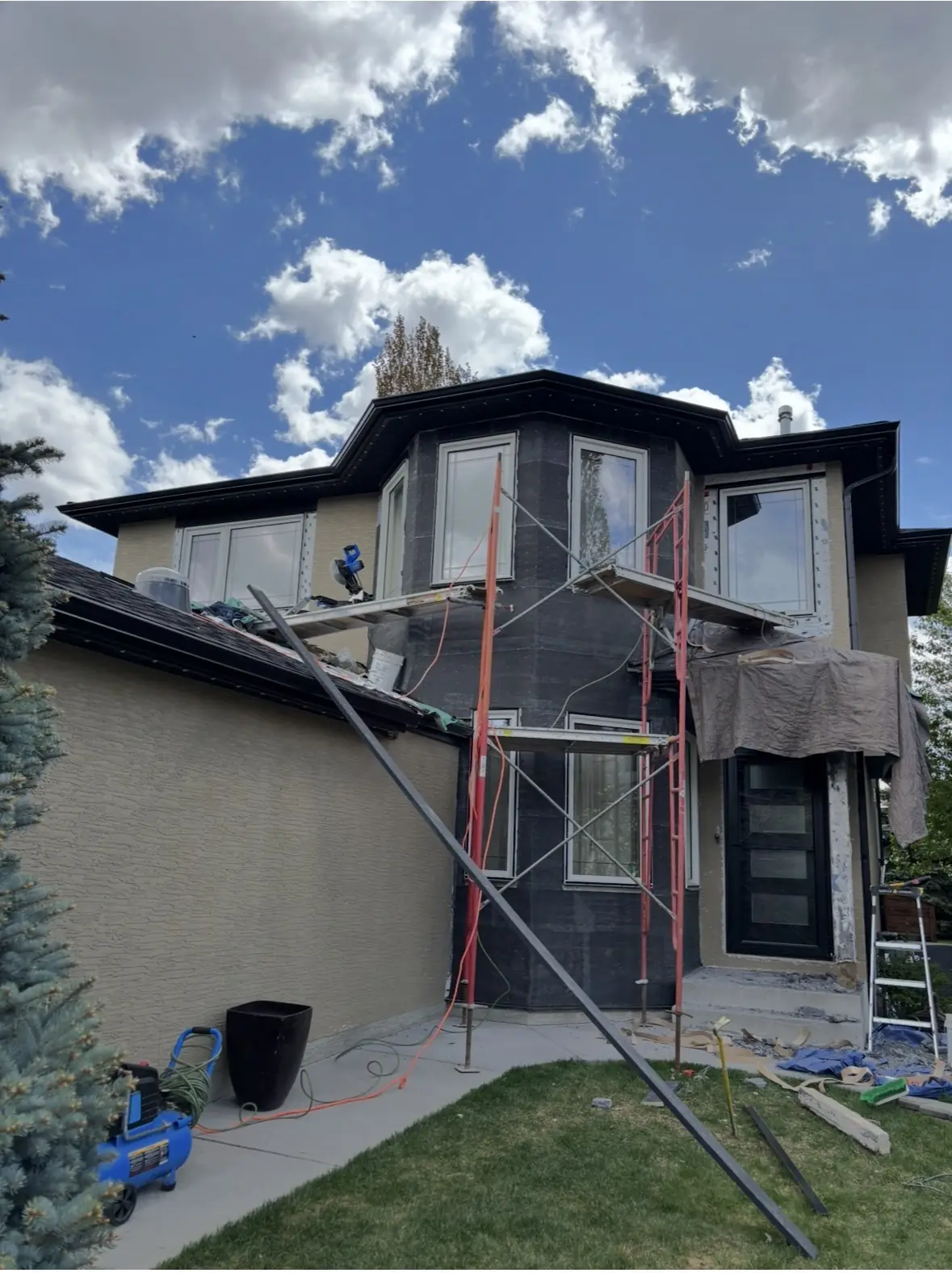 Calgary home mid stucco remediation, wall system opened and being rebuilt after damage