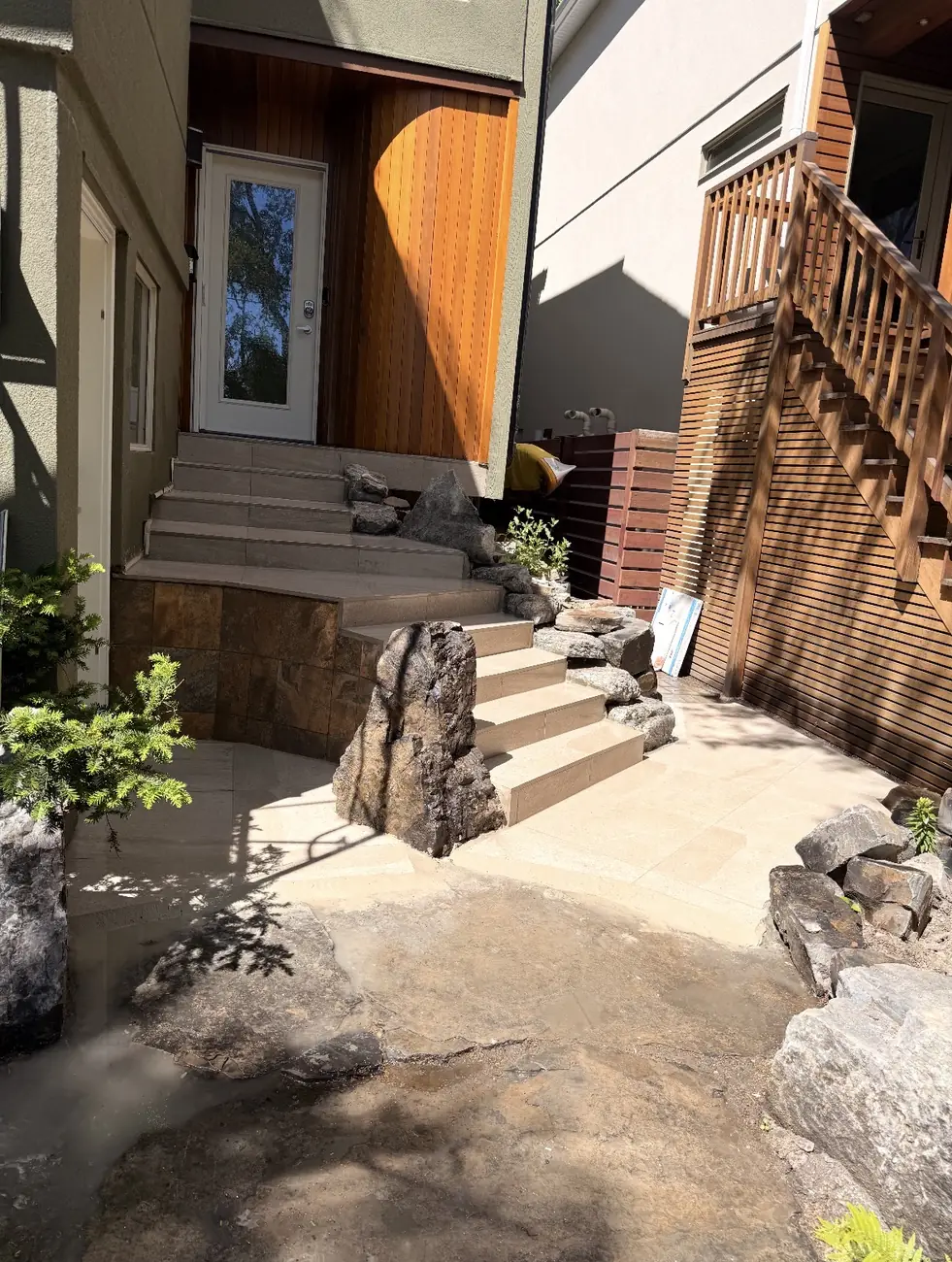 The same Calgary entry finished with porcelain tile treads set among natural boulders