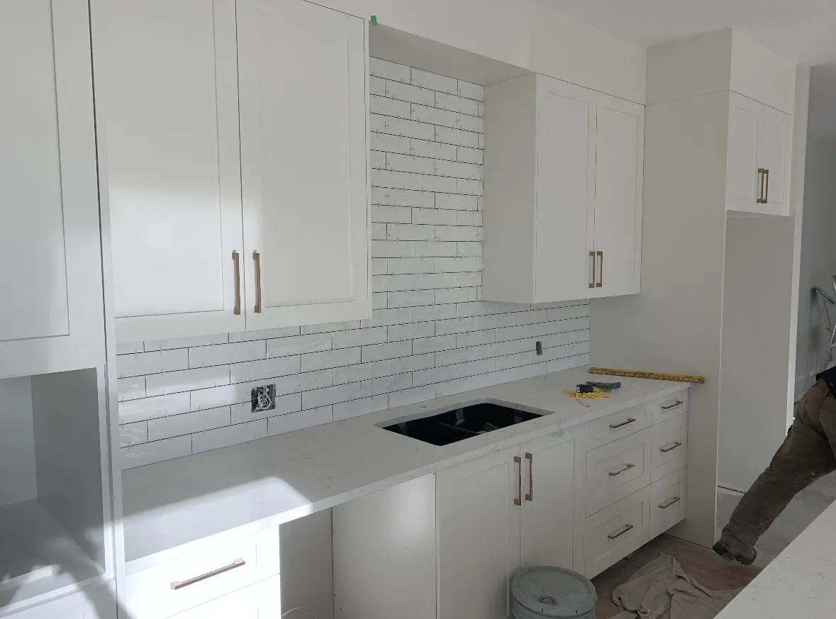 White kitchen in Calgary with a subway tile backsplash
